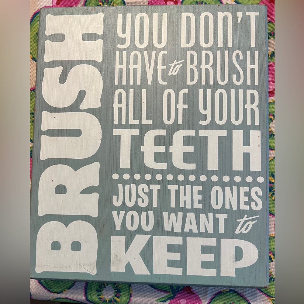 Wooden sign for bathroom decor.